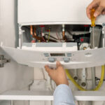 technician repairing combi gas boiler